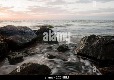 seascape, sea with stones at dawn Stock Photo