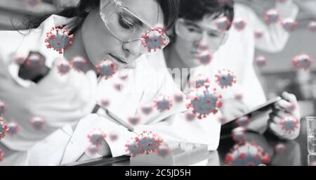 Covid-19 cells against group of scientists working in the laboratory Stock Photo