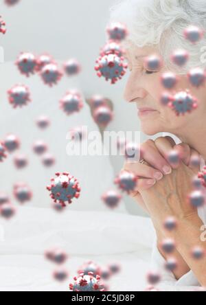 Covid-19 cells against senior woman praying Stock Photo