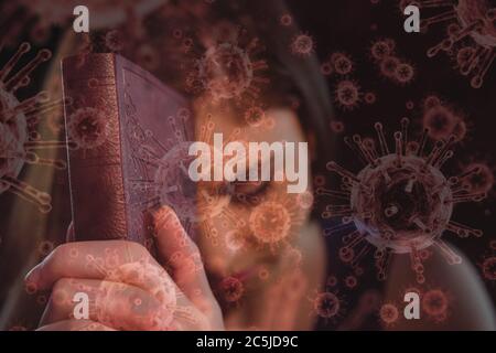 Covid-19 cells against woman with bible praying Stock Photo