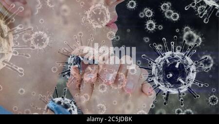 Covid-19 cells against woman praying Stock Photo