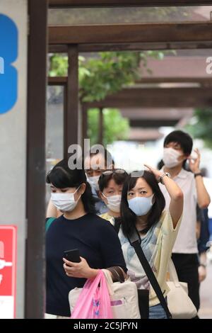 Tokyo, Japan. 3rd July, 2020. People wearing face masks wait for the bus in Tokyo, Japan, on July 3, 2020. The Tokyo metropolitan government confirmed 124 new COVID-19 infections on Friday in the capital, marking the highest daily increase in two months and the second straight day the figure has topped 100. Credit: Du Xiaoyi/Xinhua/Alamy Live News Stock Photo