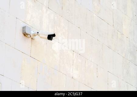 Security camera on wall of modern building Stock Photo