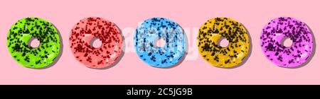 Colored donuts on a pink background. Sweet doughnut with icing. Stock Photo