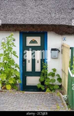 Schaprode, Germany. 07th July, 2020. View of an old front door and a thatched roof of a listed house. Credit: Stephan Schulz/dpa-Zentralbild/ZB/dpa/Alamy Live News Stock Photo