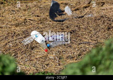 Suffolk, UK April 15 2020: washed up garbage on a river bank. Empty used dirty plastic bottles. Environmental pollution. Ecological problem Stock Photo