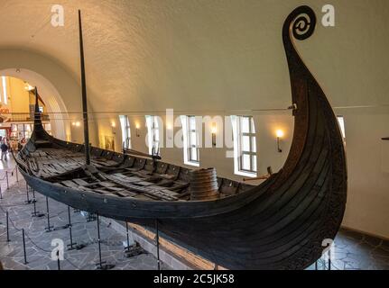 Oslo, Ostlandet / Norway - 2019/08/31: Oseberg ship excavated from ship burial archeological site, exhibited in Viking Ship Museum on Bygdoy peninsula Stock Photo