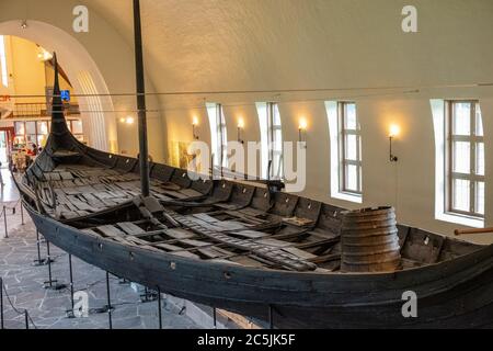 Oslo, Ostlandet / Norway - 2019/08/31: Oseberg ship excavated from ship burial archeological site, exhibited in Viking Ship Museum on Bygdoy peninsula Stock Photo