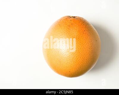 A whole pink grapefruit isolated on a white background with copy space Stock Photo
