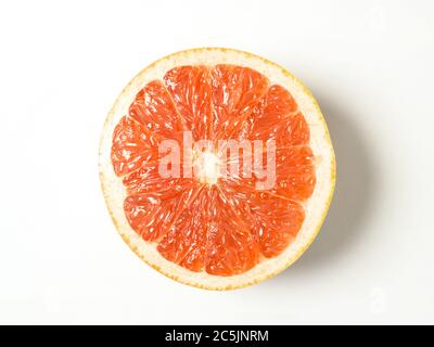 Half a pink grapefuit centred on a white background Stock Photo
