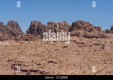 Jordan, Petra, Arid desert mountains surrounding the ruins of the Nabataean city of Petra in the Petra Archeological Park is a Jordanian National Park and a UNESCO World Heritage Site. Stock Photo