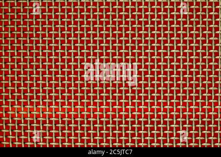 Woven wire mesh with a red background. computer desktop. Stock Photo