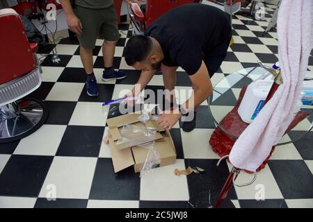 Sidcup, Kent, UK. 03rd July, 2020. Daban Ahmed partner in Red Barber Shop in Sidcup High Street prepares to reopen after covid 19 lockdown rules are relaxed by the government. Sidcup, Kent on 3 July 2020. Photo by Alan Stanford. Credit: PRiME Media Images/Alamy Live News Stock Photo