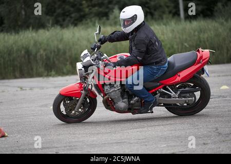 Man riding motorcycle in asphalt road curve with rural,motorcycle practice leaning into a fast corner on track Stock Photo