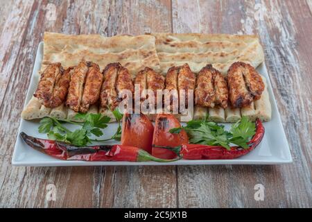 Turkish cuisine chicken wings grill. Heap fried on a grill of chicken wings with sauce and spice cocktails. Stock Photo