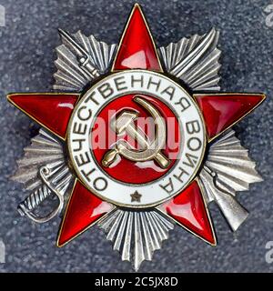 Soviet Order of the Patriotic War of second degree on a granite background. Stock Photo