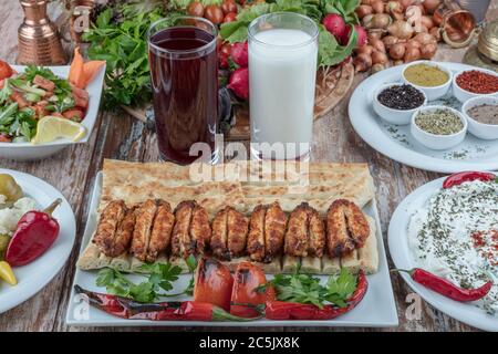 Turkish cuisine chicken wings grill. Heap fried on a grill of chicken wings with sauce and spice cocktails. Stock Photo