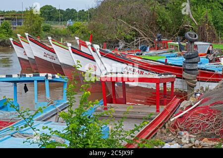 Colourful traditional wooden fishing boats moored along the coast of Guyana, South America