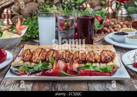 Turkish cuisine chicken wings grill. Heap fried on a grill of chicken wings with sauce and spice cocktails. Stock Photo