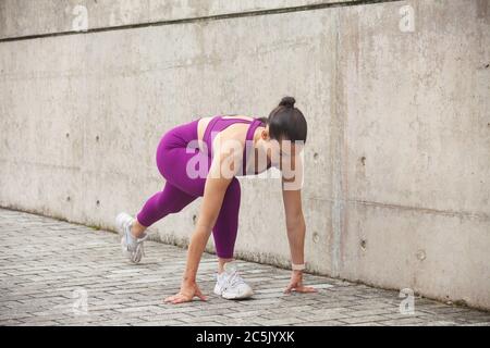 Young woman stretching her legs before a workout. Stock Photo
