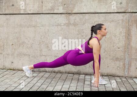 Young woman stretching her legs before a workout. Stock Photo