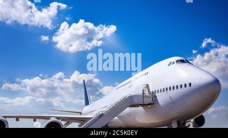 Jumbo Jet wing against blue sky Stock Photo - Alamy