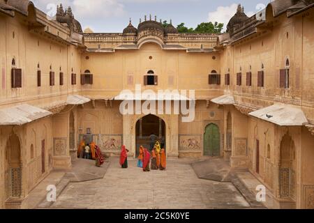 Group of Indian women in brightly coloured saris in a Rajput palace inside Nahargarh Fort overlooking Jaipur in Rajasthan, India Stock Photo