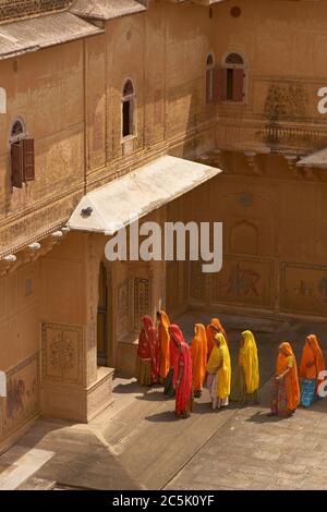 Group of Indian women in brightly coloured saris in a Rajput palace inside Nahargarh Fort overlooking Jaipur in Rajasthan, India Stock Photo