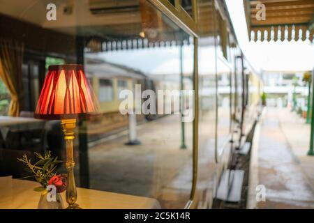 Shallow focus of an ornate, period dining table lamp seen in a First Class dining area. Stock Photo