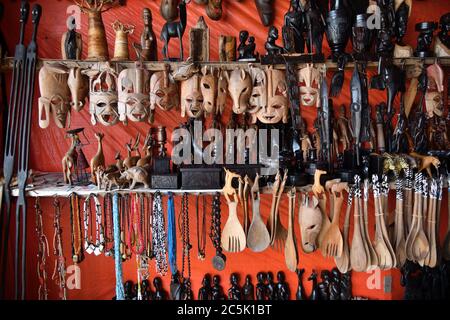 Handcrafted or handmade african souvenir. Traditional african masks, figurine and others souvenirs sold in a market stall. Kendwa, Zanzibar, Tanzania, Stock Photo