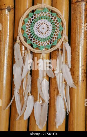 Beautiful green dream catcher on wodden background Stock Photo