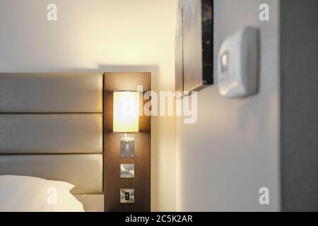 Hotel guest seen adjusting the air conditioning temperature on a premium-priced hotel room. Stock Photo