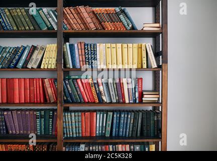 Bookcase with old books on the shelves Stock Photo