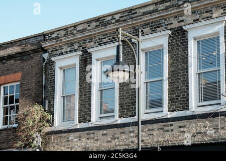 Detailed view of an victorian built two storey flats seen in an english market town. A newly installed, low energy street light is also seen. Stock Photo