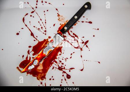A blood spatter. The knife with blood. Stock Photo