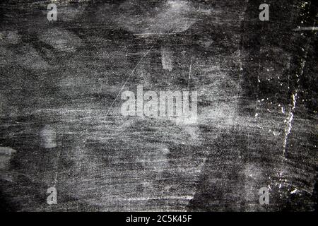 A black background with white texture on it.  A nice black background with a chalk texture on it Stock Photo