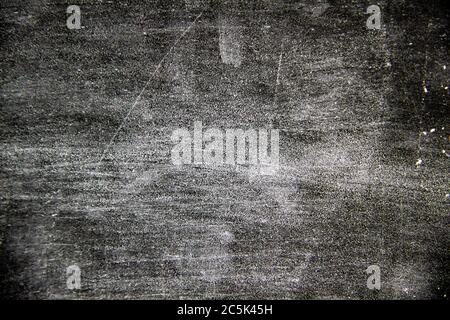 A black background with white texture on it.  A nice black background with a chalk texture on it Stock Photo