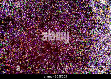 the abstract background with sparkles and glitters. A glitter in the red liquid. Colorful glitter on the background. Stock Photo