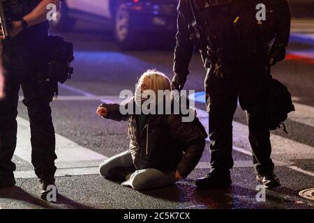 Portland, USA. 03rd July, 2020. A young woman is detained briefly, then released. A riot was declared after Black Lives Matter supporters demonstrated for the thirty-sixth day, at Portland, Oregon's Justice Center and the adjacent Mark Hatfield Federal Courthouse on July 2, 2020 to protest the murder of George Floyd in Minneapolis, Minnesota on May 25. (Photo by John Rudoff/Sipa USA) Credit: Sipa USA/Alamy Live News Stock Photo