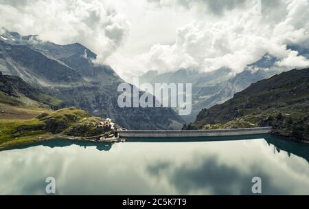 Panoramic view of man made dam in alpine mountains Stock Photo