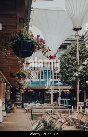 London, UK - June 13, 2020: Flower basket inside Kingly Court, a three-storey alfresco food and dining courtyard in the heart of London West End. Cour Stock Photo