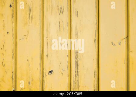 Background of sun yellow weathered wood with vertical planks. Stock Photo