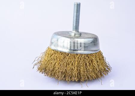 Round brass brush, to be mounted on drilling machine, over white background Stock Photo