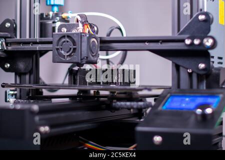 3D plastic printer during work in a factory three dimensional printing. Close-up detail. Stock Photo
