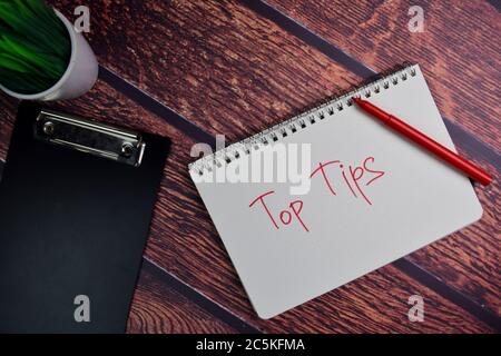Top Tips write on a book isolated wooden table. Stock Photo