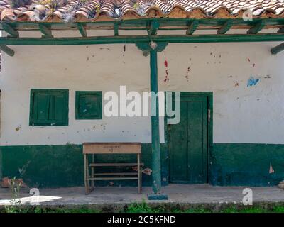 An old school desk left in front of a house at the colonial town of Chiquiza, in the Central Boyacá Province, part of the Colombian Department of Boya Stock Photo