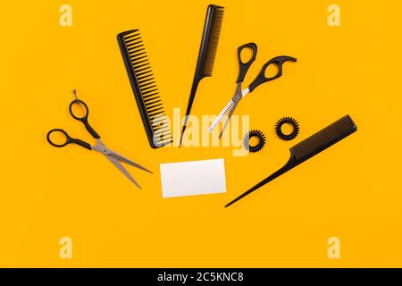 Hairdresser tools on yellow background with copy space, top view, flat lay. Stock Photo