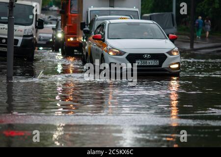 Moscow 18/06/2020 Cars in city traffic after heavy rain driving through flood Stock Photo