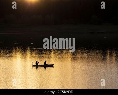 Fishermen on the water at sunset, Jackson Gulch Reservoir, Mancos State Park, Mancos, Colorado. Stock Photo