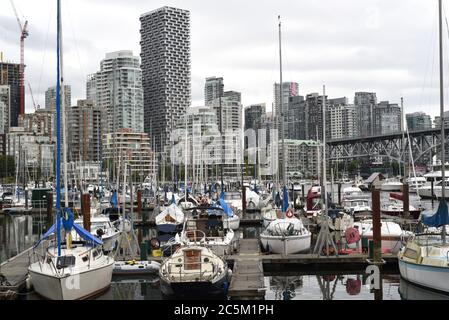 A view of sail and power boats moored in False Creek with the skyline of Vancouver, British Columbia, Canada in behind. The tallest building is Vancou Stock Photo